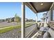 Relaxing front porch with comfortable seating offers views of the neighborhood at 7702 E 159Th Ave, Thornton, CO 80602