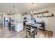 Bright kitchen and dining area featuring white cabinets, granite countertops, and stainless appliances at 7702 E 159Th Ave, Thornton, CO 80602