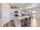 Open kitchen boasts a granite countertop island, stainless appliances, and a view of the dining area at 7702 E 159Th Ave, Thornton, CO 80602