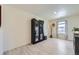 Bright living room with hardwood floors, a large cabinet, a decorative tree, and natural light from the window at 7702 E 159Th Ave, Thornton, CO 80602