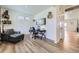 Living room features a work space and sleek laminate wood flooring at 7702 E 159Th Ave, Thornton, CO 80602