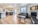 Open-concept living area combining a dining space and a living room with a fireplace at 7702 E 159Th Ave, Thornton, CO 80602