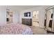 Bright bedroom showcasing a dresser and access to the bathroom, designed with neutral tones and modern furnishings at 7702 E 159Th Ave, Thornton, CO 80602