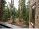 Enjoy the private balcony views of the serene forest and lush trees at 765 Columbine St # C203, Breckenridge, CO 80424