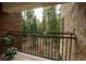 Balcony view of beautiful green forest and stone exterior at 765 Columbine St # C203, Breckenridge, CO 80424