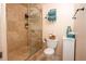 Bathroom featuring tiled walk-in shower with glass door, toilet, wall-mounted towel rack and tile flooring at 765 Columbine St # C203, Breckenridge, CO 80424
