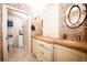 Bright bathroom with decorative wallpaper, unique mirror and vanity, plus open doorway to separate toilet area at 765 Columbine St # C203, Breckenridge, CO 80424