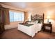 Comfortable bedroom with soft lighting, a cozy bed, and window at 765 Columbine St # C203, Breckenridge, CO 80424