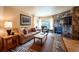Comfortable living room featuring a stone fireplace, plush seating, and warm lighting at 765 Columbine St # C203, Breckenridge, CO 80424