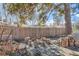 Relaxing backyard featuring a fire pit surrounded by log seating and gravel ground at 207 S Decatur St, Denver, CO 80219