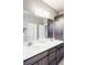 Bright bathroom featuring a double vanity, a large mirror, and modern fixtures for a luxurious feel at 16300 Paris Way, Brighton, CO 80602