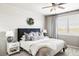 Cozy bedroom with a plush bed, shiplap accent wall, stylish decor, and great natural lighting at 16300 Paris Way, Brighton, CO 80602
