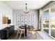 Stylish dining room featuring a contemporary light fixture, a dark sideboard, and sliding door access at 16300 Paris Way, Brighton, CO 80602