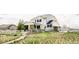 Charming two-story home with a white exterior, well-manicured lawn, and a white fence, offering a welcoming curb appeal at 16300 Paris Way, Brighton, CO 80602