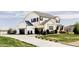 Beautiful two-story home with a black three-car garage, complemented by a well-maintained lawn at 16300 Paris Way, Brighton, CO 80602