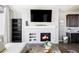 Cozy living space features a modern fireplace with a decorative mantel and built-in shelving at 16300 Paris Way, Brighton, CO 80602