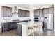 Modern kitchen with a spacious island, stainless steel appliances, and custom cabinetry at 16300 Paris Way, Brighton, CO 80602