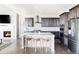 Modern kitchen with an island and stainless steel appliances, perfect for cooking and entertaining at 16300 Paris Way, Brighton, CO 80602