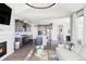 Open-concept living space featuring a fireplace, a spacious kitchen and a comfortable sectional at 16300 Paris Way, Brighton, CO 80602