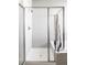 Modern shower featuring sleek glass enclosure, bright lighting, and clean white tile at 16300 Paris Way, Brighton, CO 80602