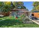 Inviting backyard with lush lawn, garden, patio, pergola, play structure, and hammock for relaxation at 2950 Hudson St, Denver, CO 80207