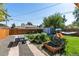 Large backyard featuring garden beds, a playground, a hammock, and a picnic table at 2950 Hudson St, Denver, CO 80207