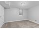 Finished basement space with carpet, window, and a door to the side at 2950 Hudson St, Denver, CO 80207