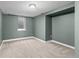 Finished basement space with carpet, light fixture, and a window at 2950 Hudson St, Denver, CO 80207