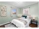 Comfortable bedroom with green walls, natural lighting, and a cozy bed at 2950 Hudson St, Denver, CO 80207