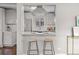 View of the updated kitchen with stainless steel appliances and breakfast bar seating at 2950 Hudson St, Denver, CO 80207