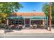 Exterior of Oblio's Pizzeria with outdoor seating under an awning, surrounded by lush greenery at 2950 Hudson St, Denver, CO 80207