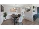 Dining room with modern chandelier, seating for four, and faux brick accent wall at 7700 W Glasgow Pl # 11C, Littleton, CO 80128