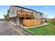 Townhome exterior features a balcony, wood fence, a garage and a small yard with a fire lane at 7700 W Glasgow Pl # 11C, Littleton, CO 80128