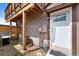 Exterior front door showing adjacent wooden fence and a gas grill at 7700 W Glasgow Pl # 11C, Littleton, CO 80128