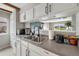 Kitchen sink with backyard view featuring stainless steel appliances and white cabinetry at 7700 W Glasgow Pl # 11C, Littleton, CO 80128