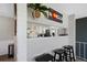 Breakfast bar featuring black stools and an opening looking into the bright white kitchen at 7700 W Glasgow Pl # 11C, Littleton, CO 80128