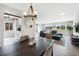 Open living room and kitchen layout, featuring hardwood floors, large windows, and modern furnishings at 7700 W Glasgow Pl # 11C, Littleton, CO 80128
