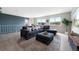 Living room features a sectional couch, wood floors, and views of the outside at 7700 W Glasgow Pl # 11C, Littleton, CO 80128