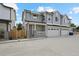 A gray two-story home featuring a two-car garage and a welcoming front porch at 4002 Upham St, Wheat Ridge, CO 80033