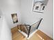 Modern staircase with wood steps and metal railing, showcasing clean lines and natural light at 4002 Upham St, Wheat Ridge, CO 80033