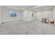 Bright finished basement with carpet, two windows, and area for desk at 3888 Grand Baker St, Aurora, CO 80019