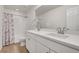 Bright bathroom featuring a double sink vanity and tiled shower with a stylish curtain at 3888 Grand Baker St, Aurora, CO 80019