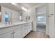 Well-lit bathroom with double sinks and a view into a bedroom at 3888 Grand Baker St, Aurora, CO 80019