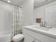 Contemporary bathroom featuring vanity sink and shower with a striped curtain at 3888 Grand Baker St, Aurora, CO 80019