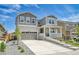 Inviting two-story home with a charming front porch, beautiful stone accents, and a well-manicured lawn at 3888 Grand Baker St, Aurora, CO 80019