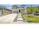 Charming two-story home featuring a welcoming porch and landscaped front yard with a concrete staircase at 3888 Grand Baker St, Aurora, CO 80019