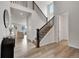 Bright foyer with a staircase, hardwood floors, and an open view of the living room at 3888 Grand Baker St, Aurora, CO 80019