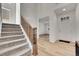 Inviting foyer with hardwood floors, carpeted staircase, and an open layout at 3888 Grand Baker St, Aurora, CO 80019