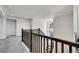 Upstairs hallway with a modern chandelier and dark wood banister overlooking the staircase at 3888 Grand Baker St, Aurora, CO 80019