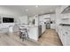 Spacious kitchen featuring an island with bar seating, stainless steel appliances, and open layout to living area at 3888 Grand Baker St, Aurora, CO 80019